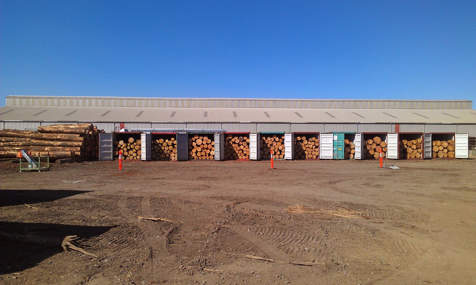 Shipping containers loaded with logs for export
